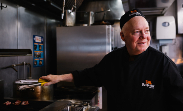 chef holding tongs