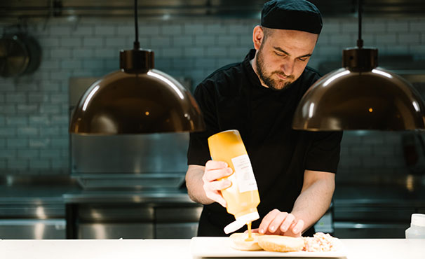 kitchen-staff-preparing-a-burger