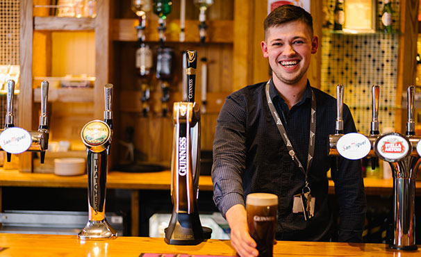 smiling-bar-staff-serving-a-drink