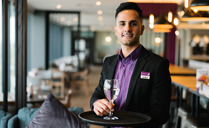 premier-inn-colleague-holding-a-drink-on-a-tray-carousel-image